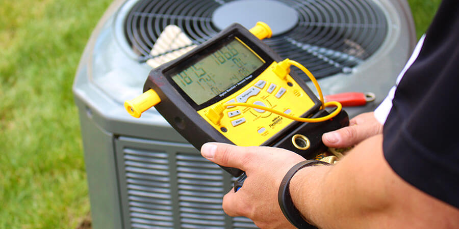 Technician checking air conditioning unit